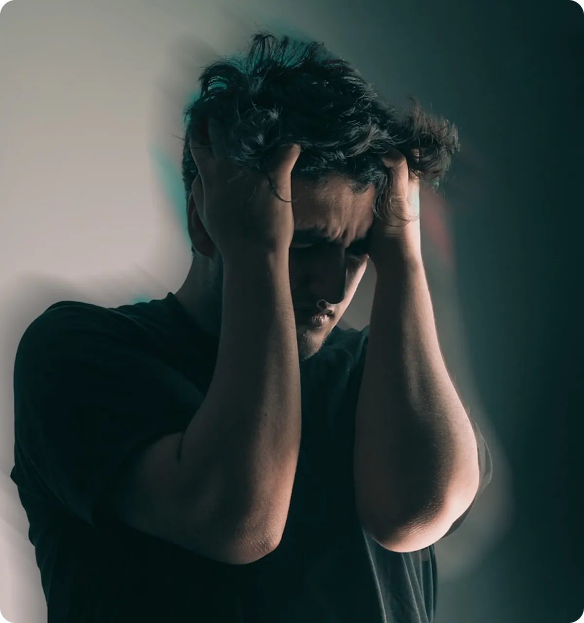 Man holding head in hands showing signs of depression and anxiety needing mental health counseling in Virginia Beach
